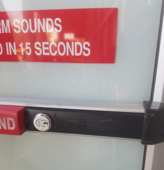 Alarmed panic bar and exit device on a storefront door in College Station, TX