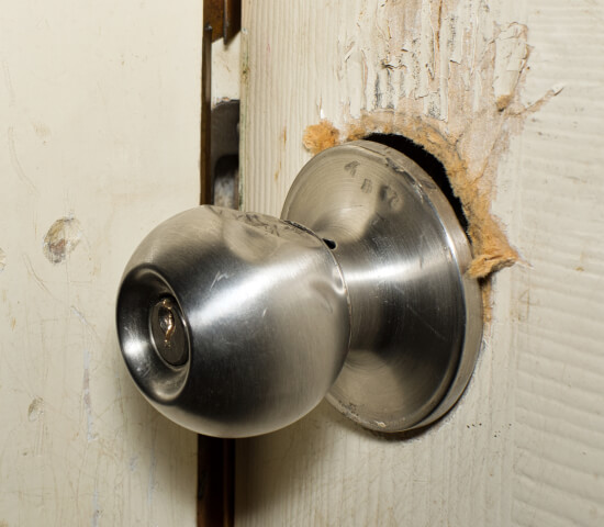 forced-entry-door-security-repair-fort-worth-image Fort Worth locksmith re-securing a door after a forced entry