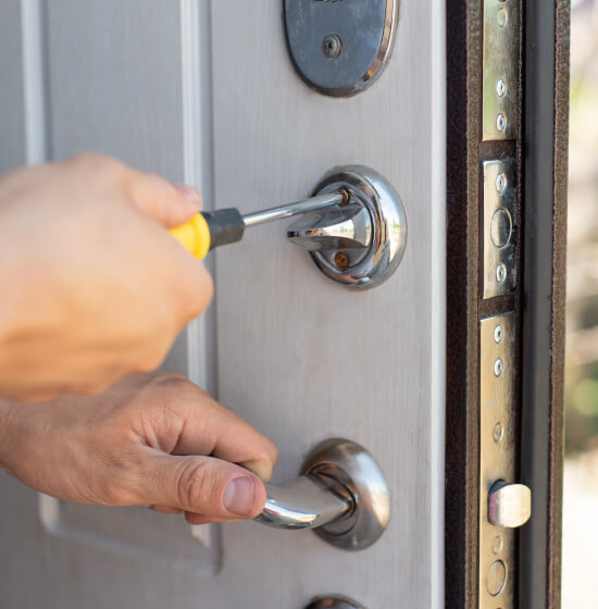 multi-point-lock-service-security-door-fort-worth-image Fort Worth locksmith servicing a multi-point lock on a security door