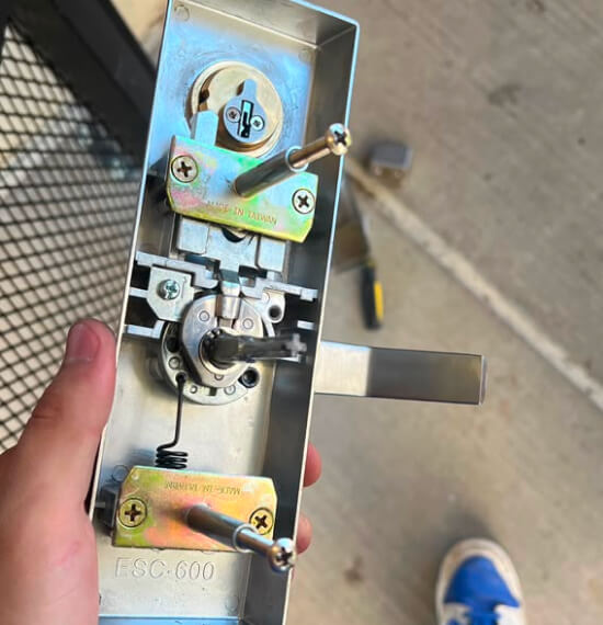 Locksmith repairing a commercial door lock in Waco, TX